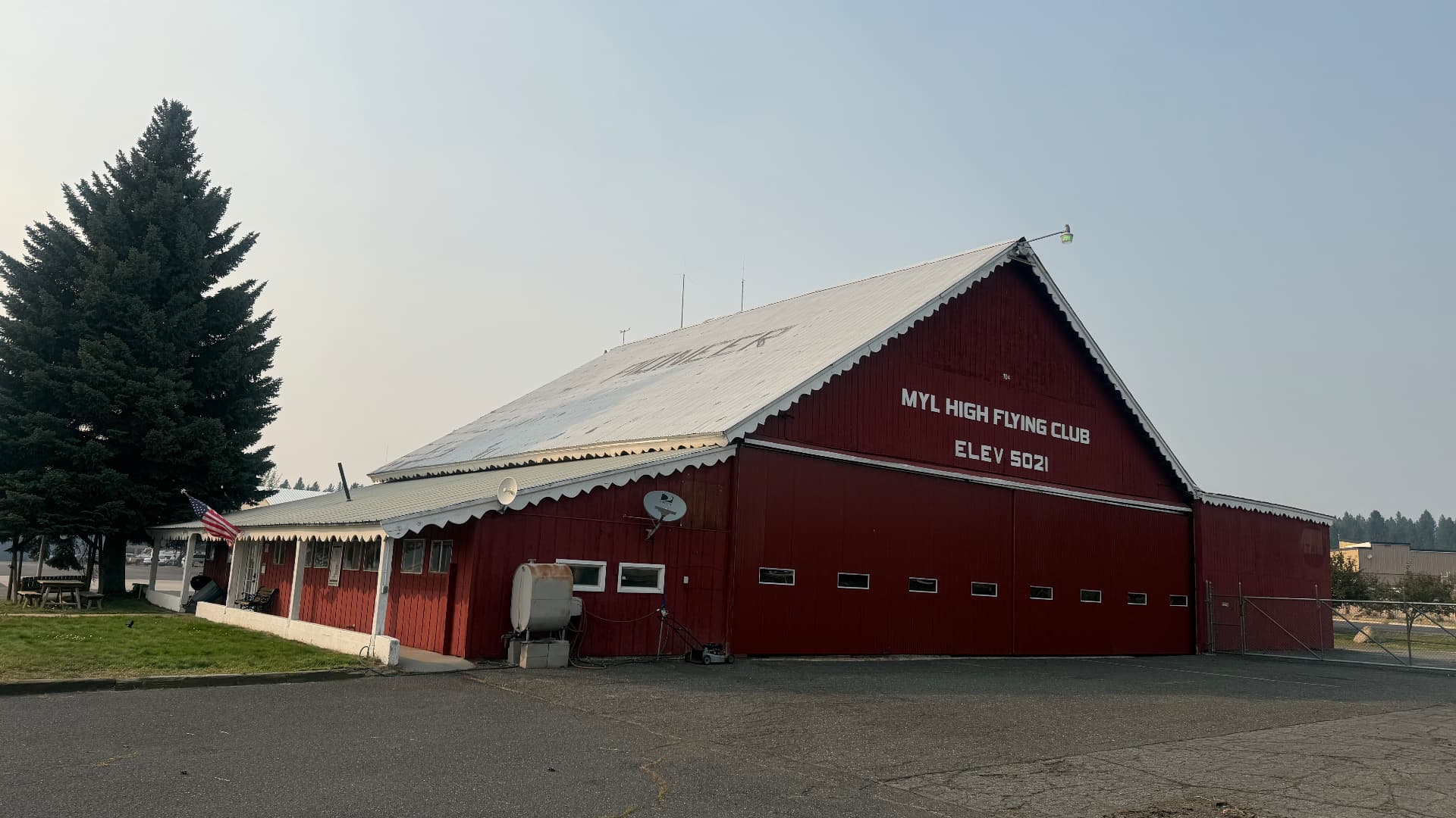 The red Pioneer Hangar at McCall Municipal Airport with MYL High Flying Club painted on the gable