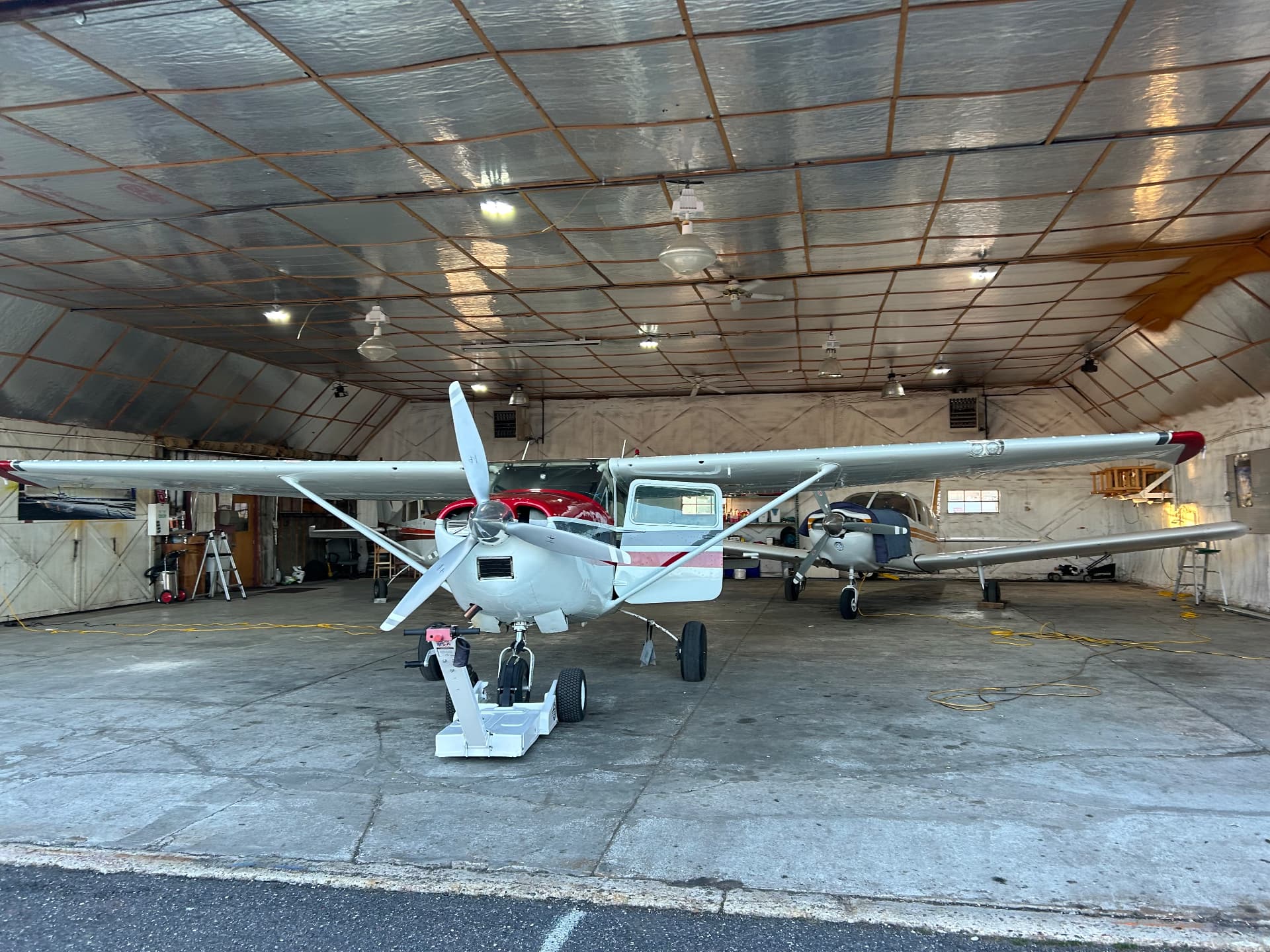 Cessna 182 and the Cherokee Six parked inside the club hangar