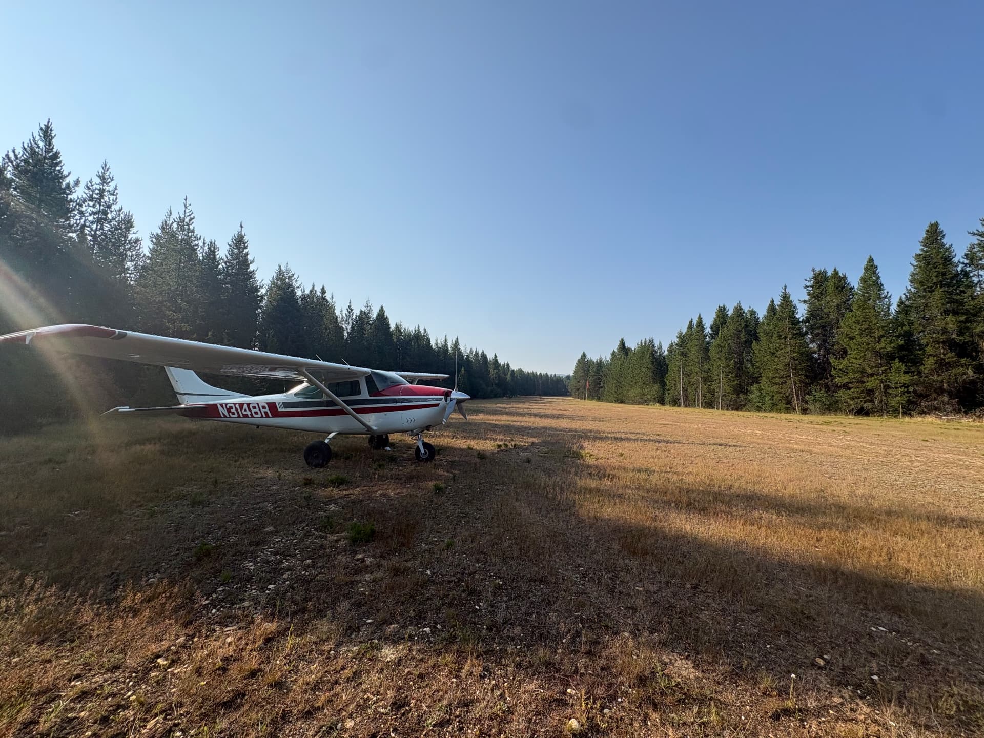 Cessna 182 N3148R parked on a backcountry grass strip