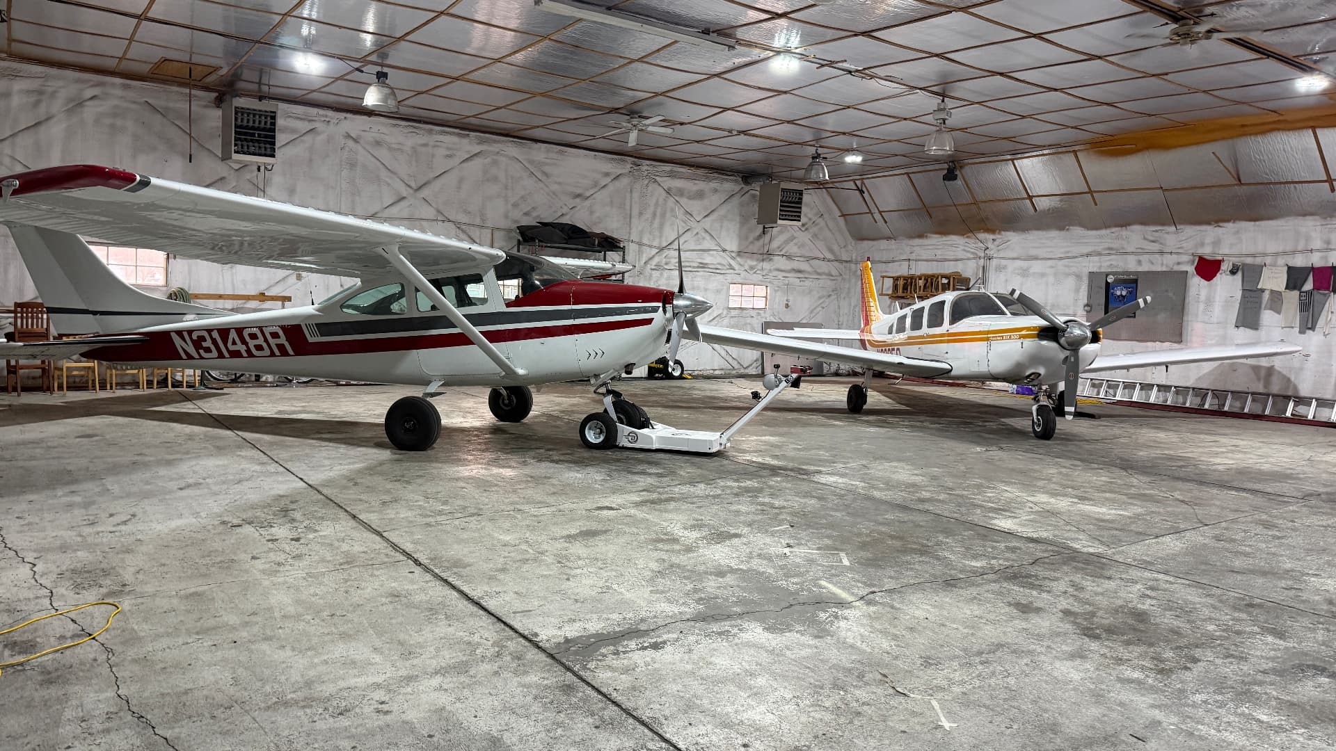 Cessna 182 N3148R and the Piper Cherokee Six parked inside the hangar bay